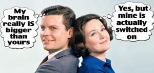 1960s SMILING MAN AND WOMAN STANDING BACK TO BACK WITH ARMS FOLDED 